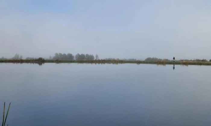 Sole angler as early morning mist rises