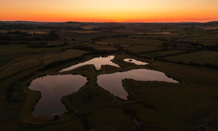 Summer sunset over Chatton Lakes